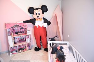 Location mascotte Mickey Mouse surprenant une petite fille de 3 ans lors d'une fête.